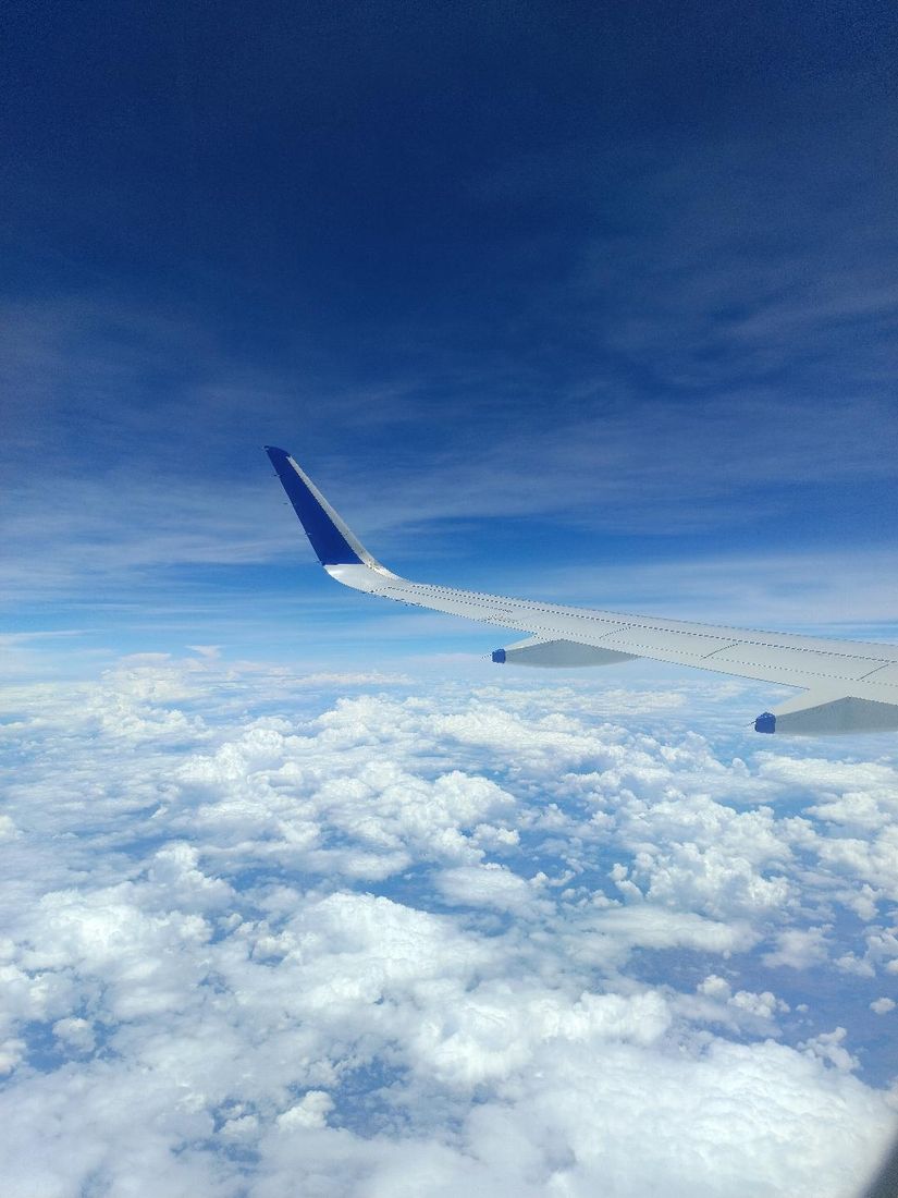 Aircraft wing above a sea of clouds