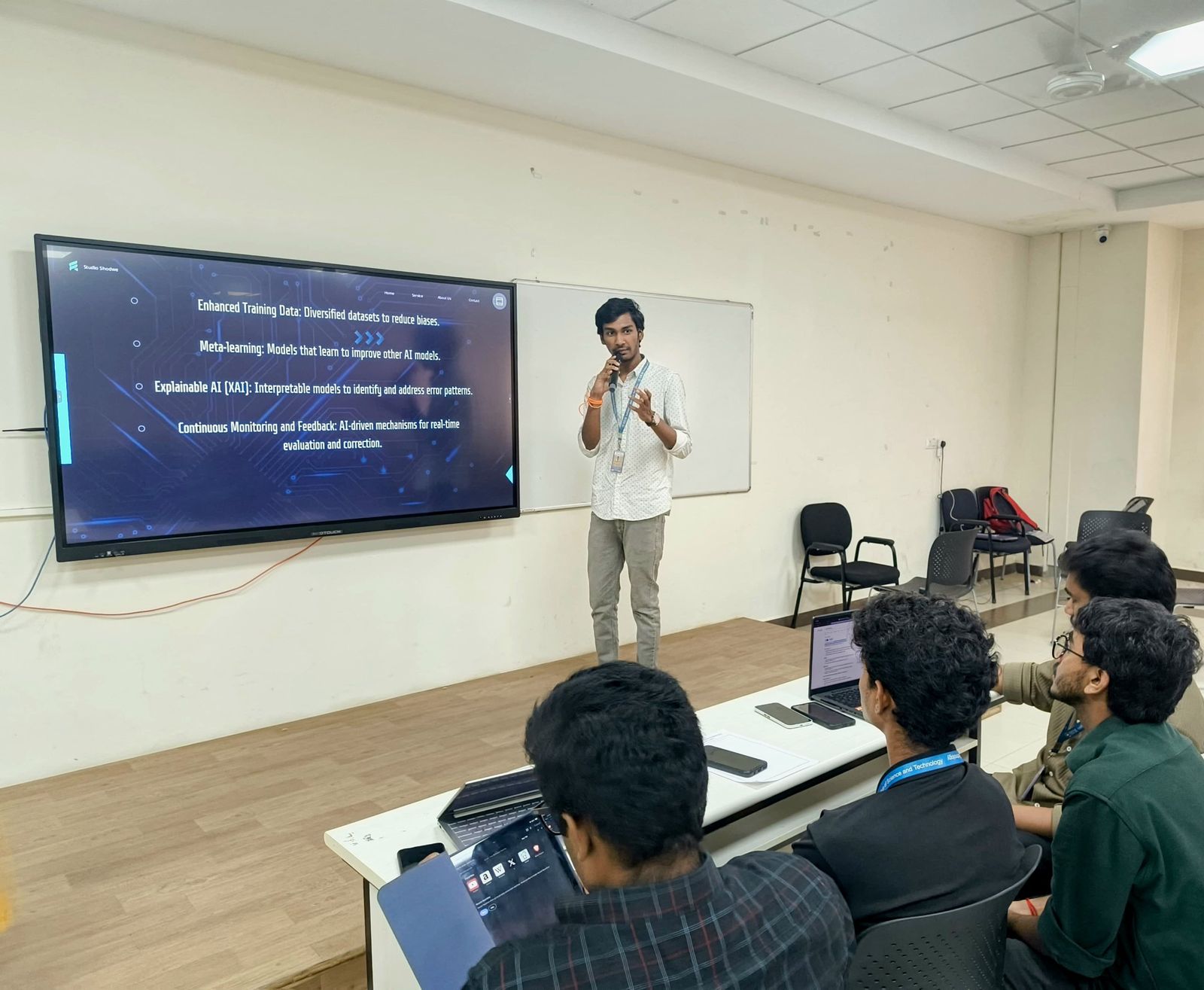 Nuthan presenting slides on explainable AI and meta-learning to students